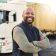 Delivery, container and happy truck driver moving industry cargo and freight at a shipping supply chain or warehouse. Smile, industrial and black man ready to transport ecommerce trade goods or stock